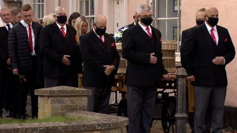 Mourners at the funeral of Simon Dobbin