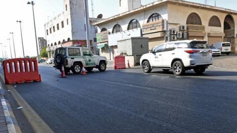 Saudi police close a street leading to a non-Muslim cemetery in the Saudi city of Jeddah where a bomb struck a World War I commemoration attended by European diplomats on 11 November 2020