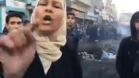 Screen grab from Twitter video showing angry Palestinian woman in Gaza Strip pointing at camera