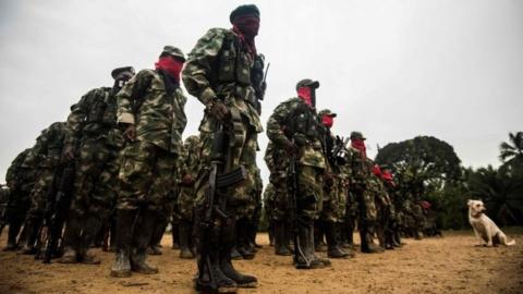 This file photo taken on November 21, 2017 shows Members of the "Omar Gomez" Western War Front of the National Liberation Army (ELN) guerrilla lining up in their camp on the banks of the San Juan River, Choco department, Colombia.