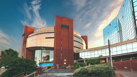 A large circular building on a sunny day