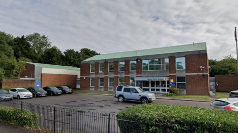 The current Canley Police Station made of brick and glass with a green roof