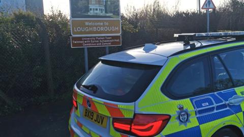 Police car in front of a Loughborough sign