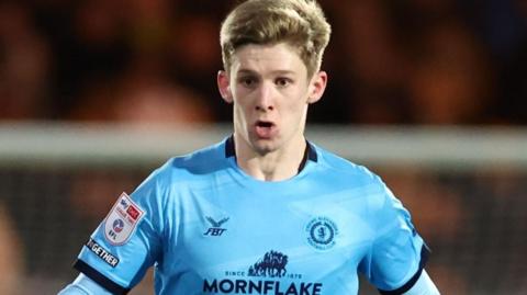 Crewe Alex defender James Connolly in the club's powder blue away strip