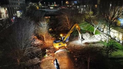 Plant machinery cutting down a tree in Plymouth's Armada Way.