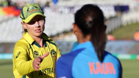 Meg Lanning shakes hands with Harmanpreet Kaur after Australia beat India in the Women's T20 World Cup semi final