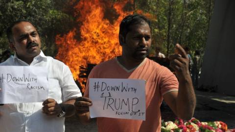 Supporters of the killed Indian engineer Srinivas Kuchibhotla, who was shot dead in the US state of Kansas, take part in a protest against racism and US President Donald Trump, in front of Kuchibhotla's burning funeral pyre, in Hyderabad on February 28, 2017.