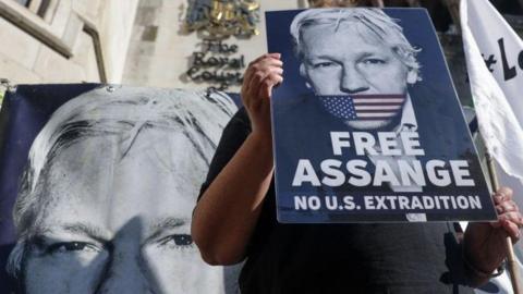 Placards supporting Julian Assange outside courthouse