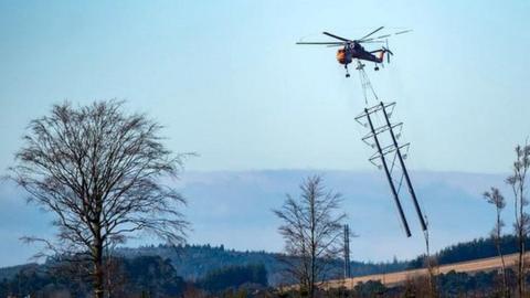 Helicopter and electricity towers