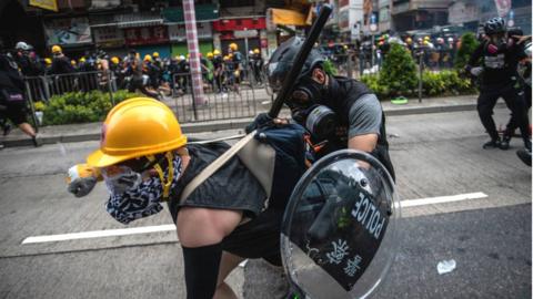 Protestor in Hong Kong being held back by police