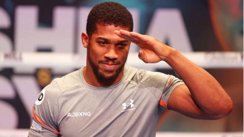 Anthony Joshua salutes the crowd at a workout