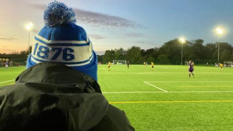 Bangor 1876 fan watches the games