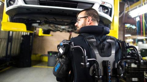 A Ford factory worker wearing a robotic exosuit