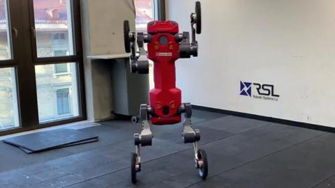 A four-wheeled red robot standing upright on its rear wheels