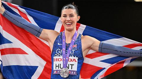 amy hunt with GB flag and silver medal