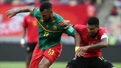 Cameroon's Eric Maxim Choupo-Moting defends the ball against Mozambique's Luis Miquissone