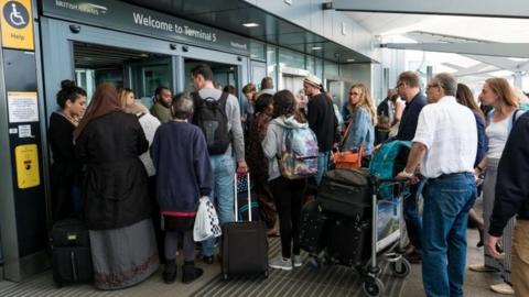 People queuing at Heathrow after BA IT chaos