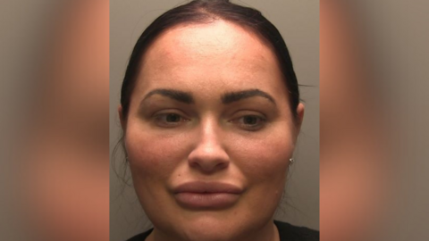 Police custody picture of Natasha Allarakhia. She has black hair tied back. 