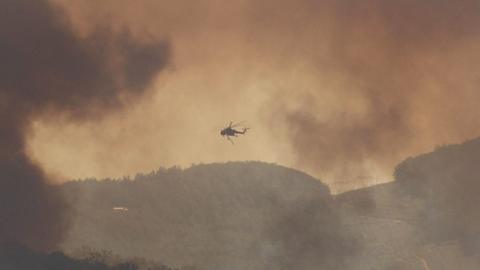 Helicopter attempting to put out fire