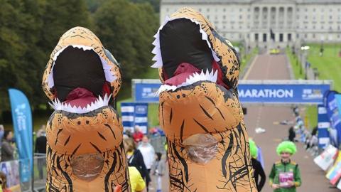 Runners dressed as dinosaurs take part in Belfast City Marathon 2021