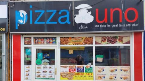 Exterior of PizzaUno takeaway's shopfront in Nelson, East Lancashire