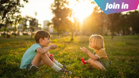 Two children with bubbles in a park 