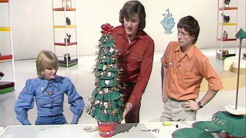 Lesley, Peter, and John around their homemade Christmas tree.