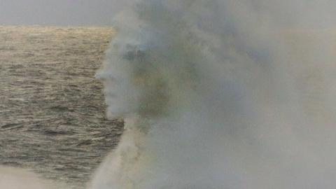 A face appears in a wave