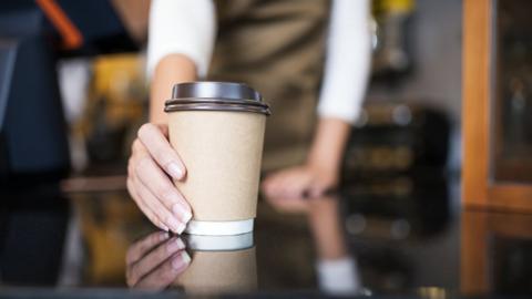 Barista holding a coffee cup