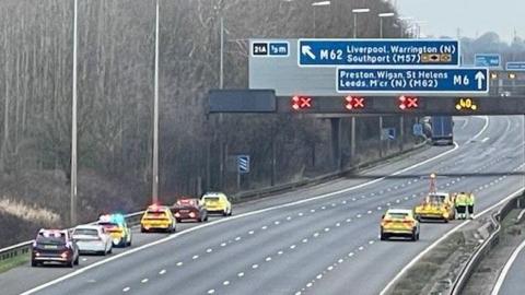 View of police cars on hard shoulder and right lane on an emptied motorway.