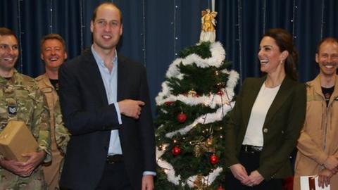 The Duke and Duchess of Cambridge standing by a Christmas tree at RAF Akrotiri base