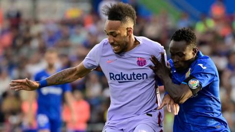 Barcelona forward Pierre-Emerick Aubameyang (L) fights for the ball with Getafe defender Djene Dakonam