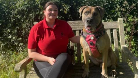 Beccy Hill on bench with dog