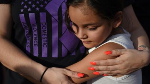 Joanna Villarreal hugs her mother during a vigil