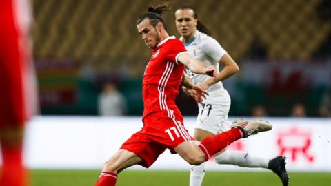 Gareth Bale of Wales and Diego Laxalt of Uruguay