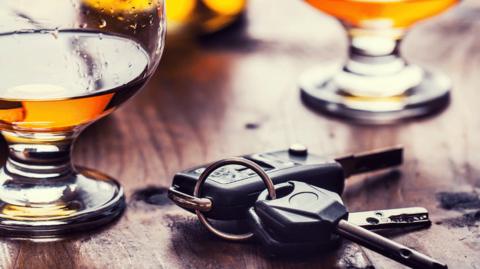 Glass of brandy next to car keys