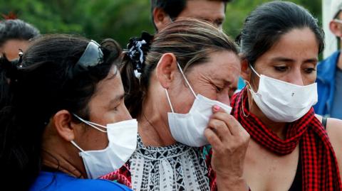 People mourn their loved ones at a mass funeral after a mudslide hit Mocoa, Colombia, 3 April 2017.