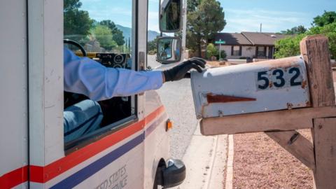 United States Postal Service mail carrier Frank Colon, 59, delivers mail amid the coronavirus pandemic on April 30, 2020 in El Paso, Texas.