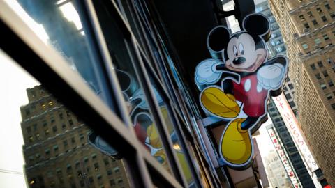 An image of Mickey Mouse, the official mascot of The Walt Disney Company, is displayed outside the Disney Store in New York