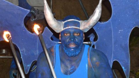 Samuel Thomas performs as a blue devil