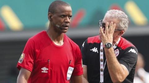 Tunisia coach Mondher Kebaier remonstrates with referee Janny Sikazwe