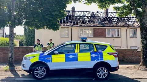 Police remain at the scene of the blaze
