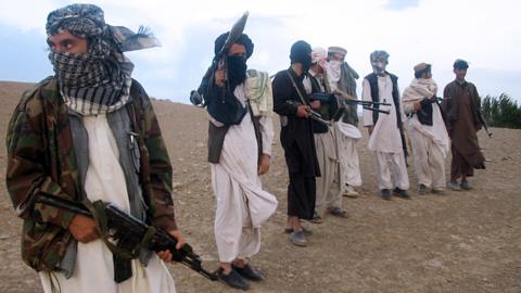 This file photo taken on September 26, 2008 shows fighters with Afghanistan's Taliban militia standing on a hillside at Maydan Shahr in Wardak province, west of Kabul