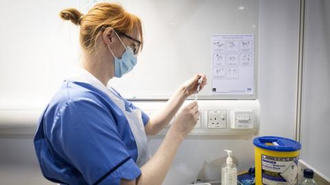 Nurse with Covid vaccine