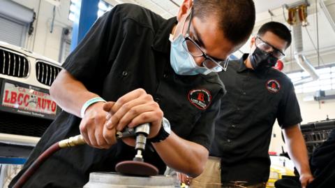 Hernan Galaviz cleans a brake disc brakes during auto technician class at LBCC Pacific Coast Campus in Long Beach on Thursday, November 4, 2021.