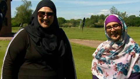 Two women enjoying golf for the first time