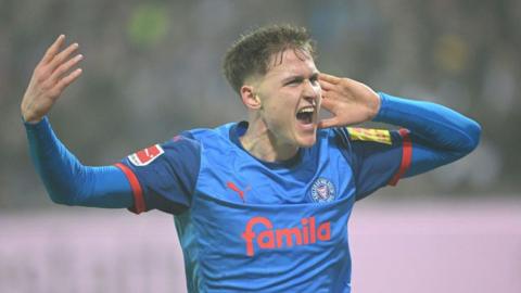 Holstein Kiel striker Phil Harres celebrates scoring his team's second goal during the Bundesliga match against Borussia Dortmund 