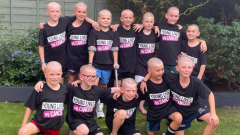 Group photo of the boys after they shaved their heads