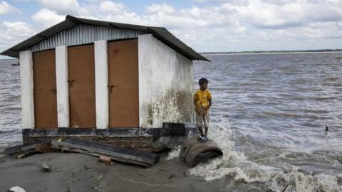 A boy who lost their belongings in river erosion takes shelter in a shelter home which is now eroded again.