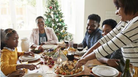 Family around dining table at Christmas